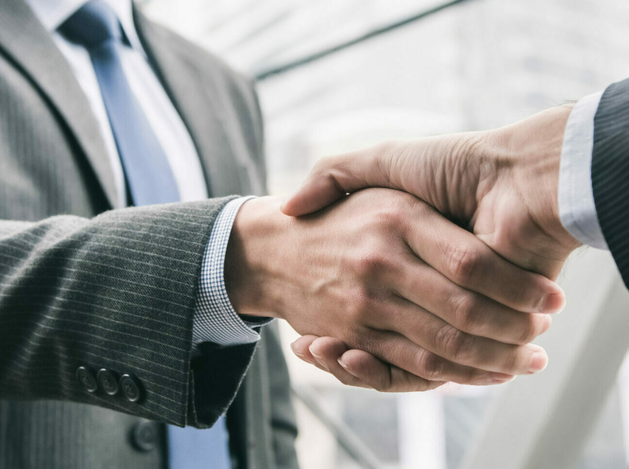 Businessman making handshake with partner - greeting, dealing, merger and acquisition concepts, panoramic banner